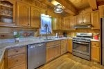 Kitchen with granite counter tops and stainless applainces and a gas stove